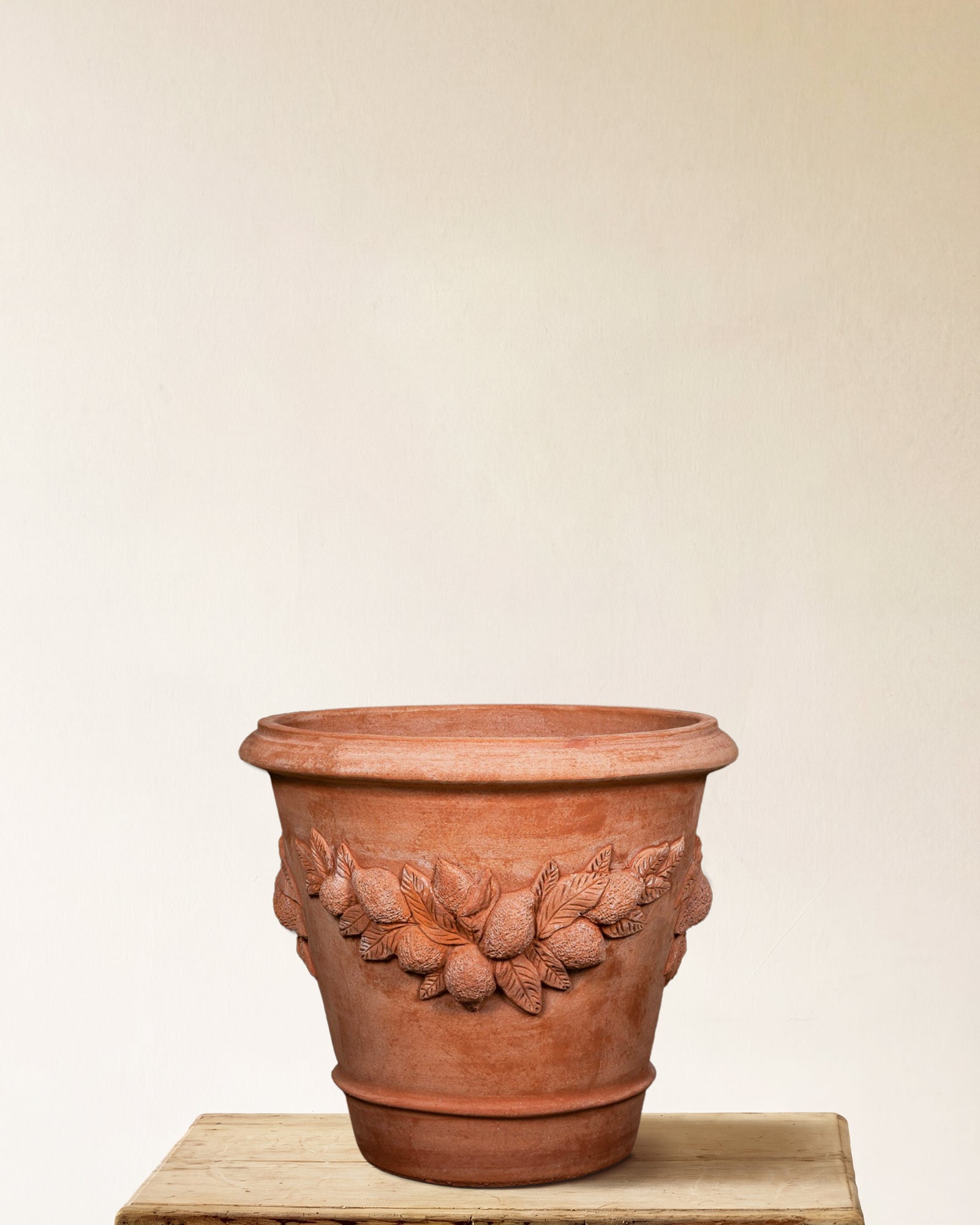 Italian terracotta planter with sculpted lemon and leaf relief band, made in Impruneta, Medium