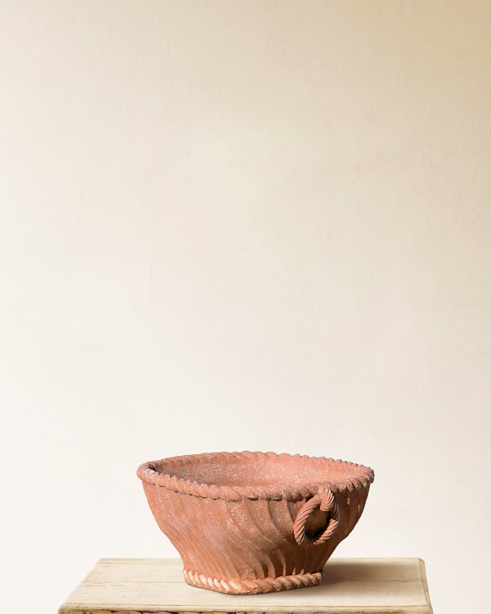 Italian terracotta planter with low open form, rope rim and base detail, and fluted sides, made in Impruneta, 17" x 9"