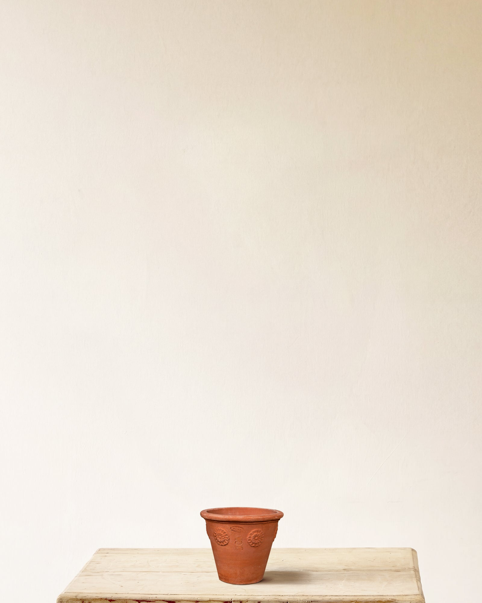 Italian terracotta planter with tapered form and carved rosette detailing, made in Impruneta, 9" x 8"