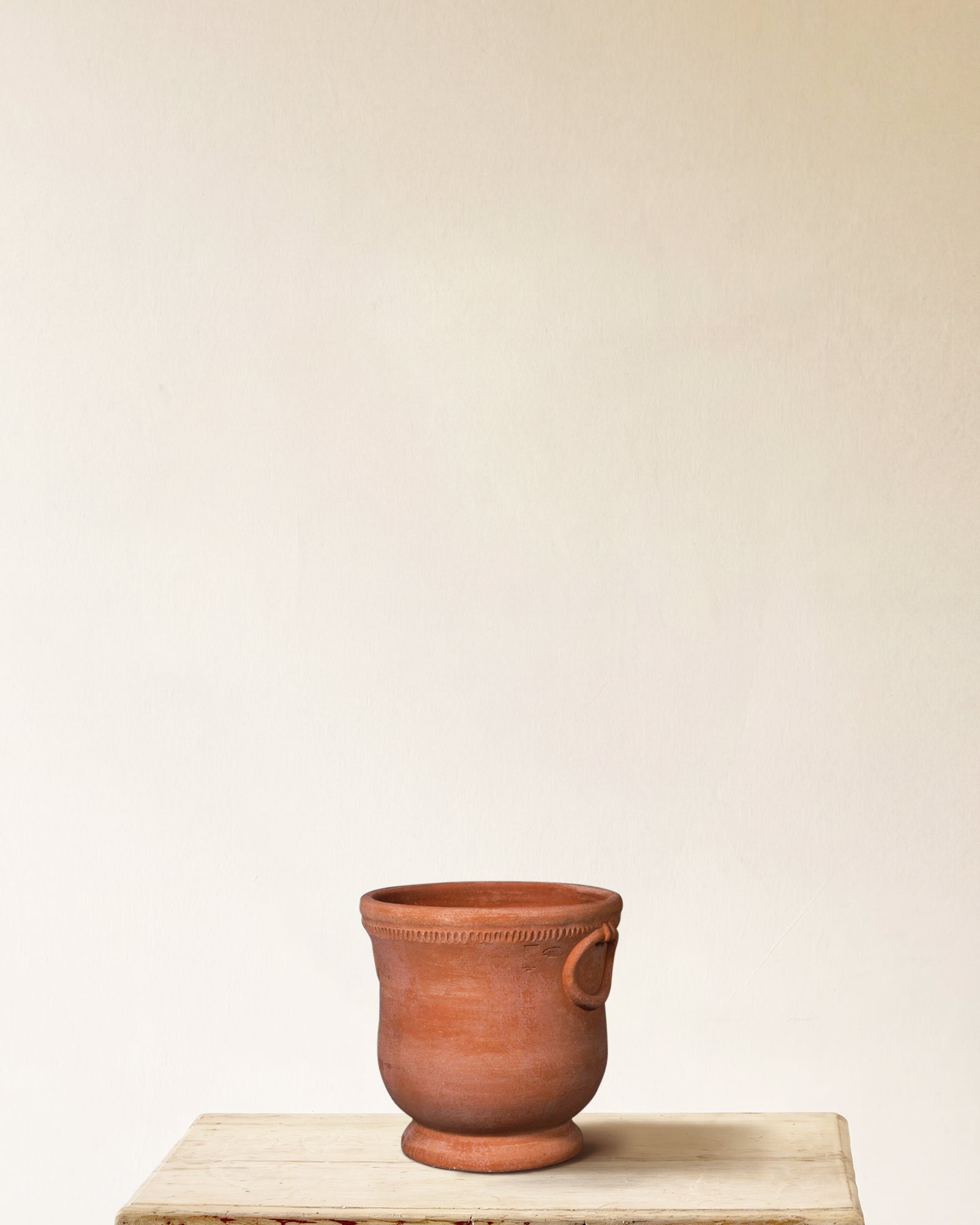 Italian terracotta planter with rounded body, flared base and ring handles, made in Impruneta, 13" x 15", angled view