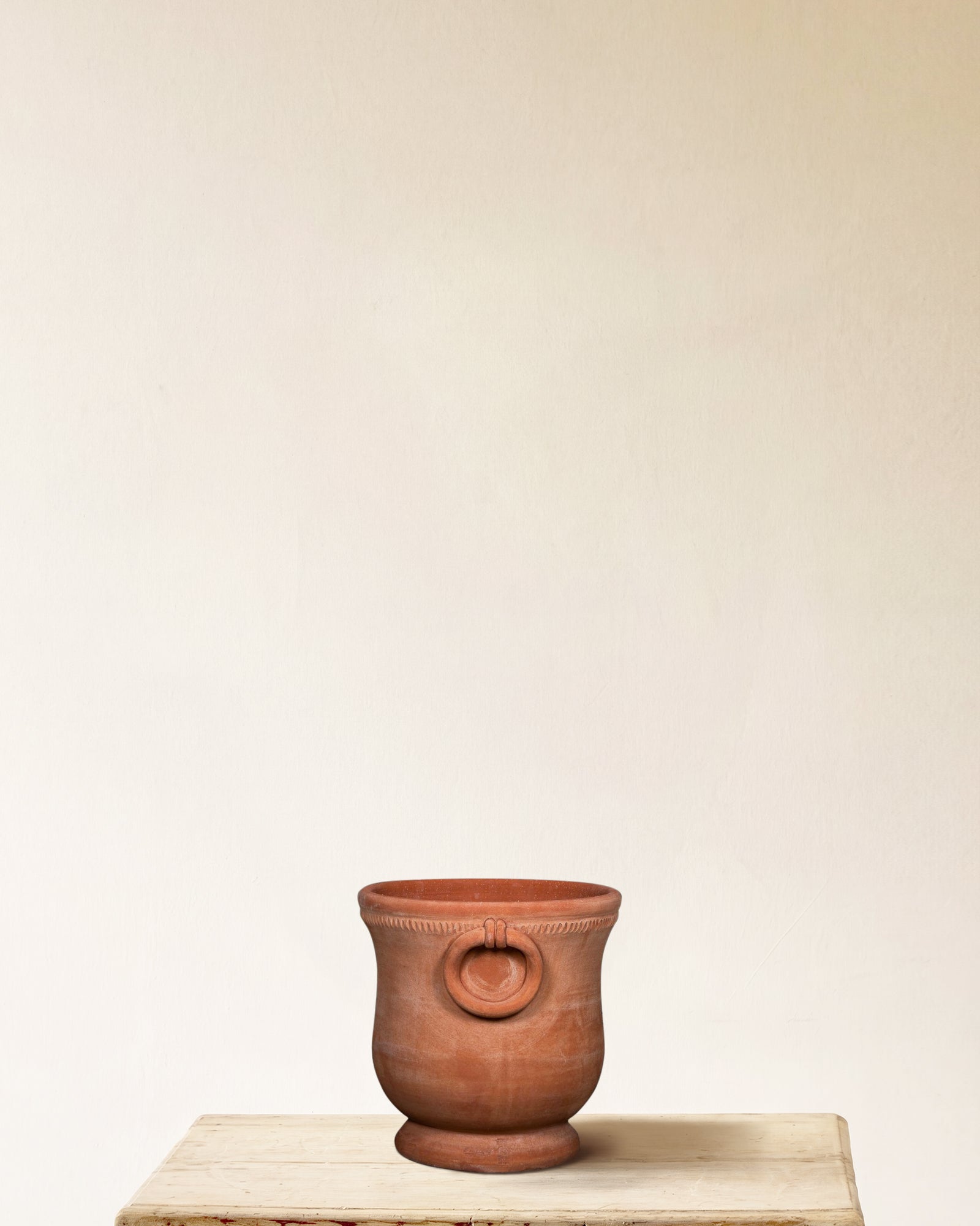Italian terracotta planter with rounded body, flared base and ring handles, made in Impruneta, 13" x 15", side view