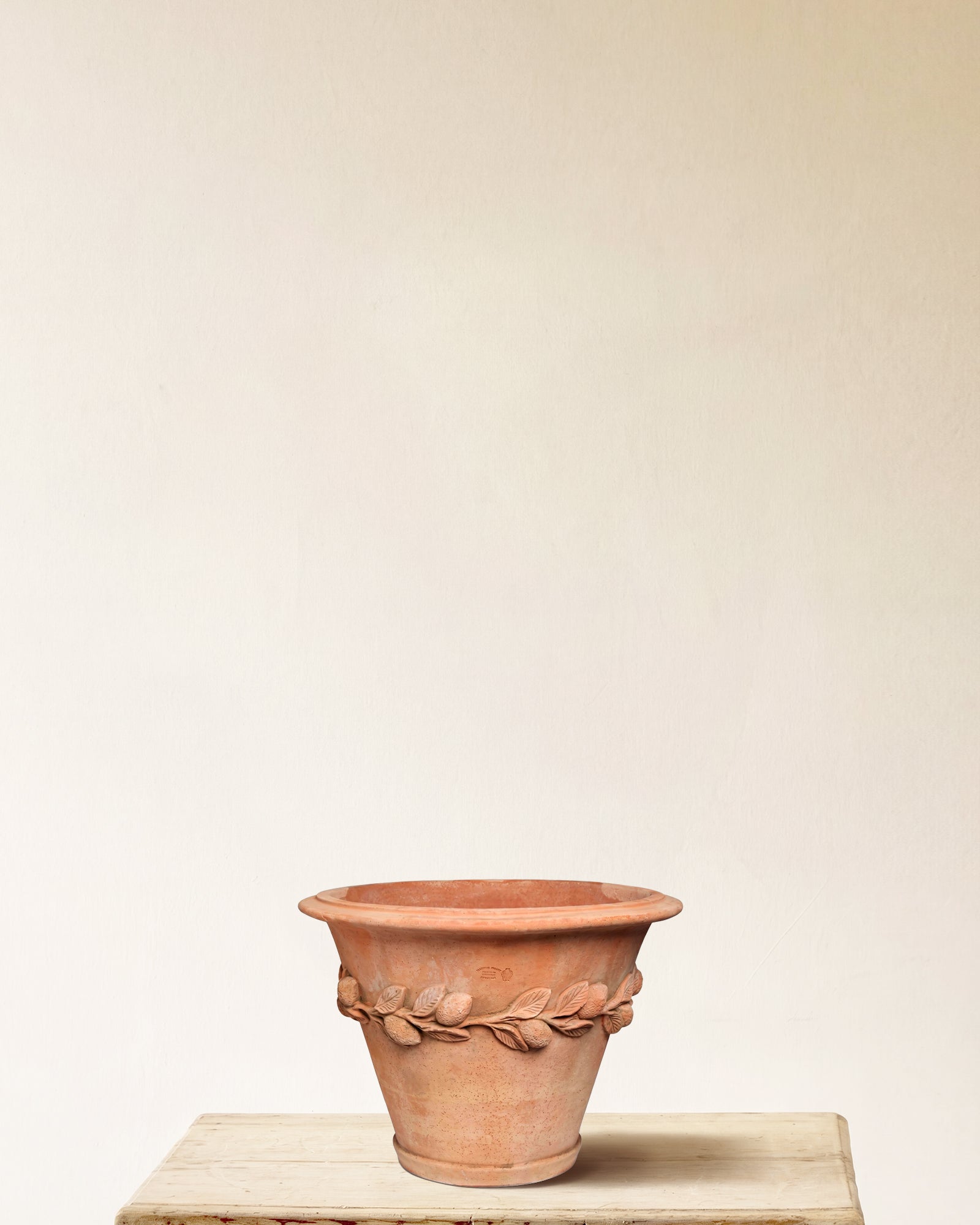 Italian terracotta planter with flared form and sculpted lemon and leaf band, made in Impruneta, 17" x 16"