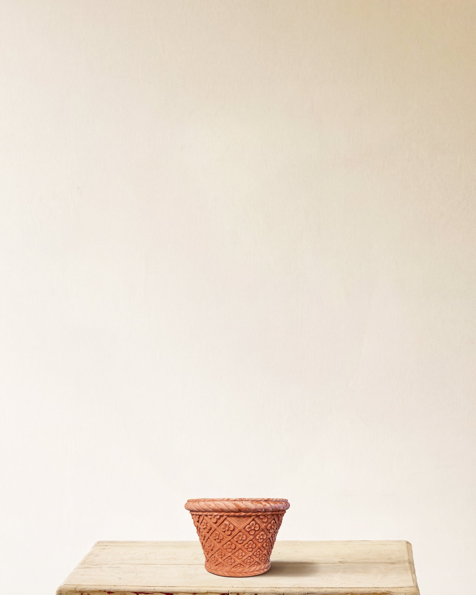 Italian terracotta planter with conical form and carved daisy lattice, made in Impruneta, 11" x 9"