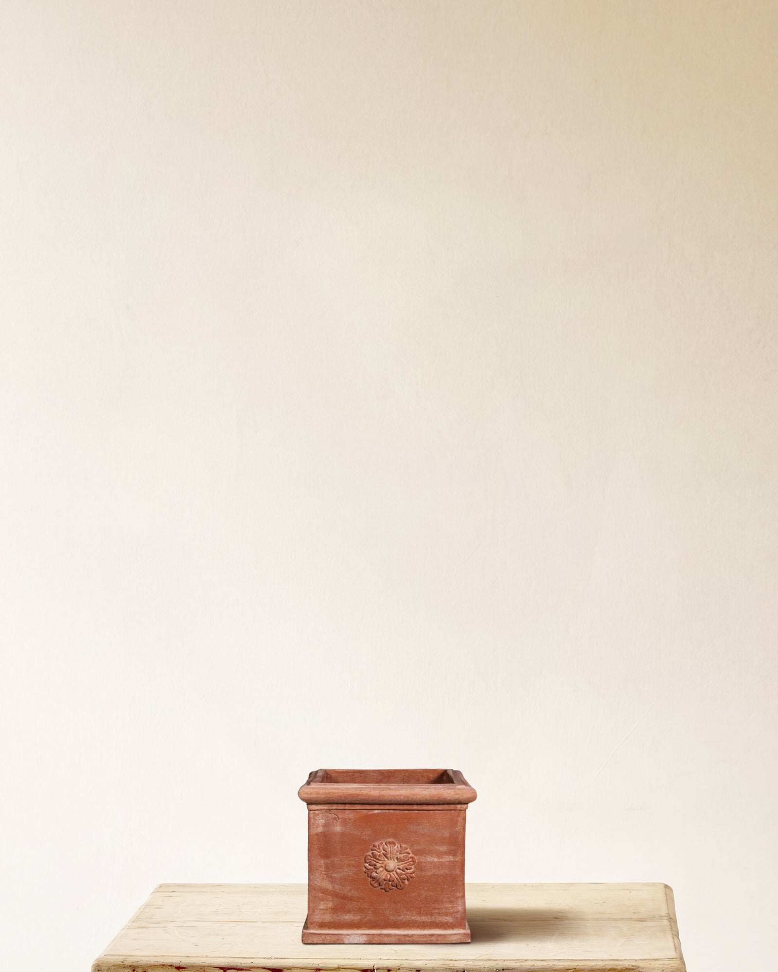 Italian terracotta square planter with carved rosette on each face, made in Impruneta, 13" x 12"