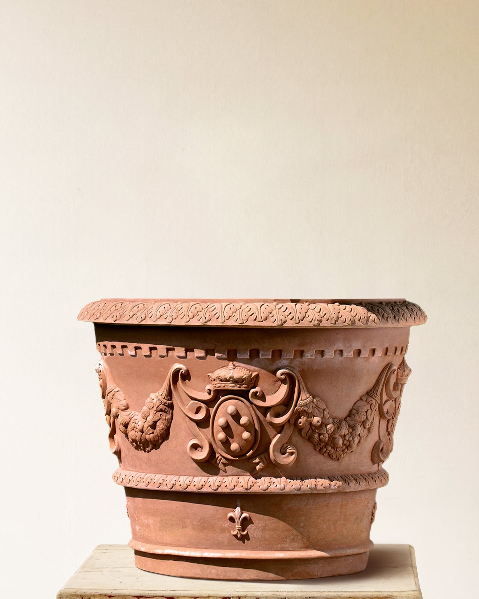Italian terracotta planter with broad flared form and sculpted Medici crest in garland band, made in Impruneta, 33" x 31"