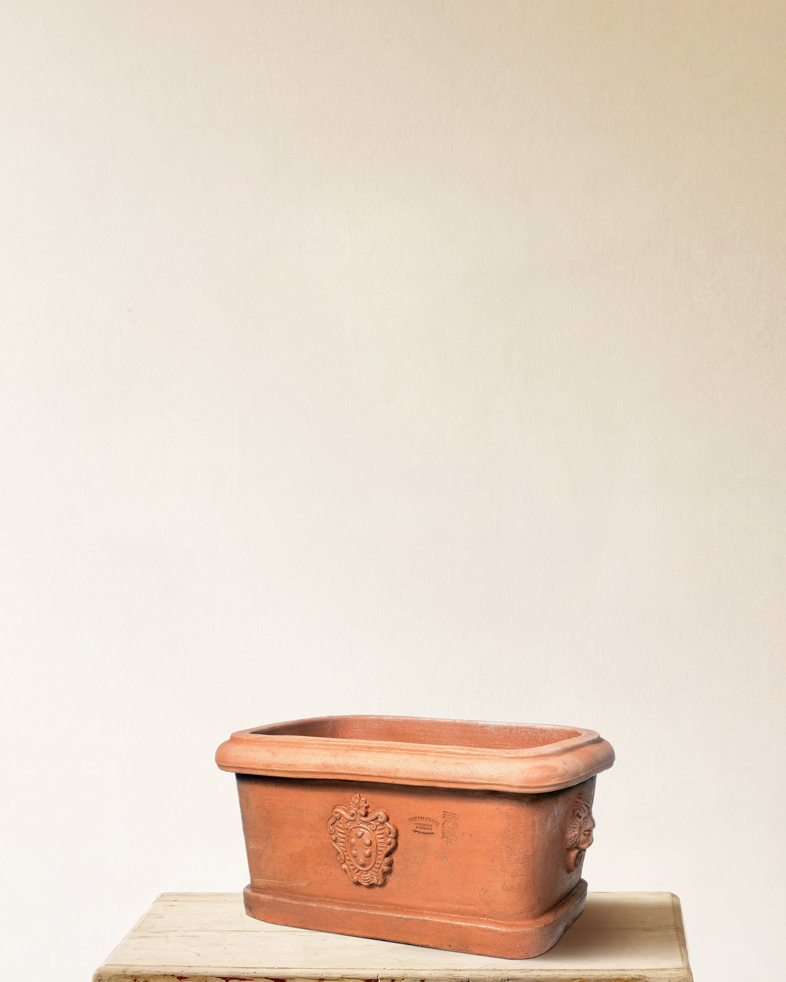 Italian terracotta rectangular planter with raised crest detail, rounded corners, made in Impruneta, 21" x 15" x 11"