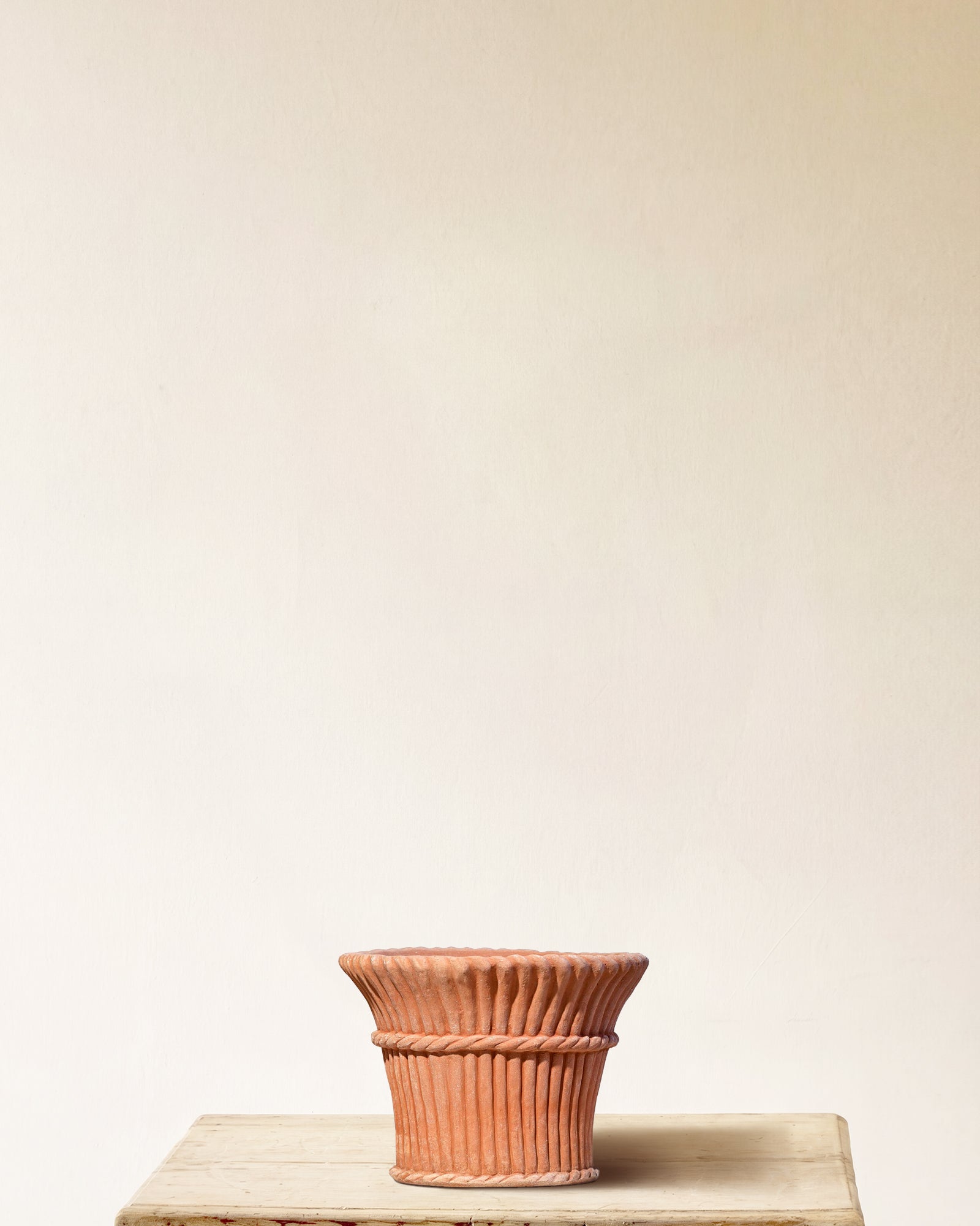 Italian terracotta planter with full-height vertical ribbing and sculpted band and knot at midpoint, made in Impruneta, 14" x 12", back view
