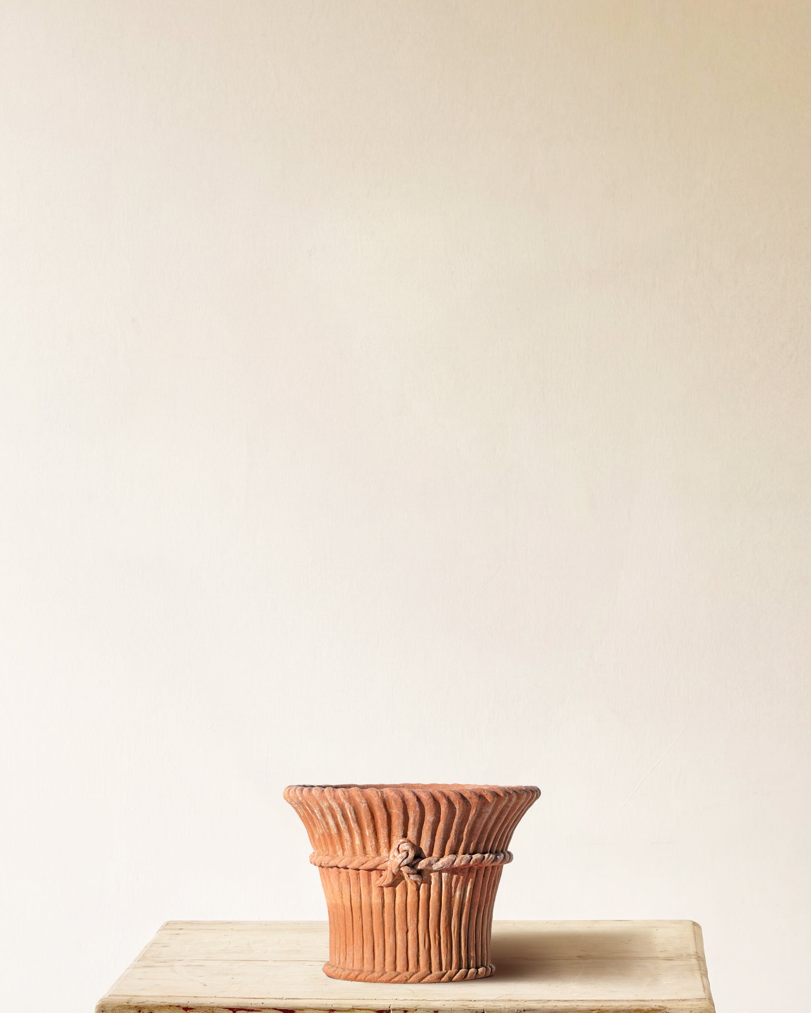 Italian terracotta planter with full-height vertical ribbing and sculpted band and knot at midpoint, made in Impruneta, 14" x 12"