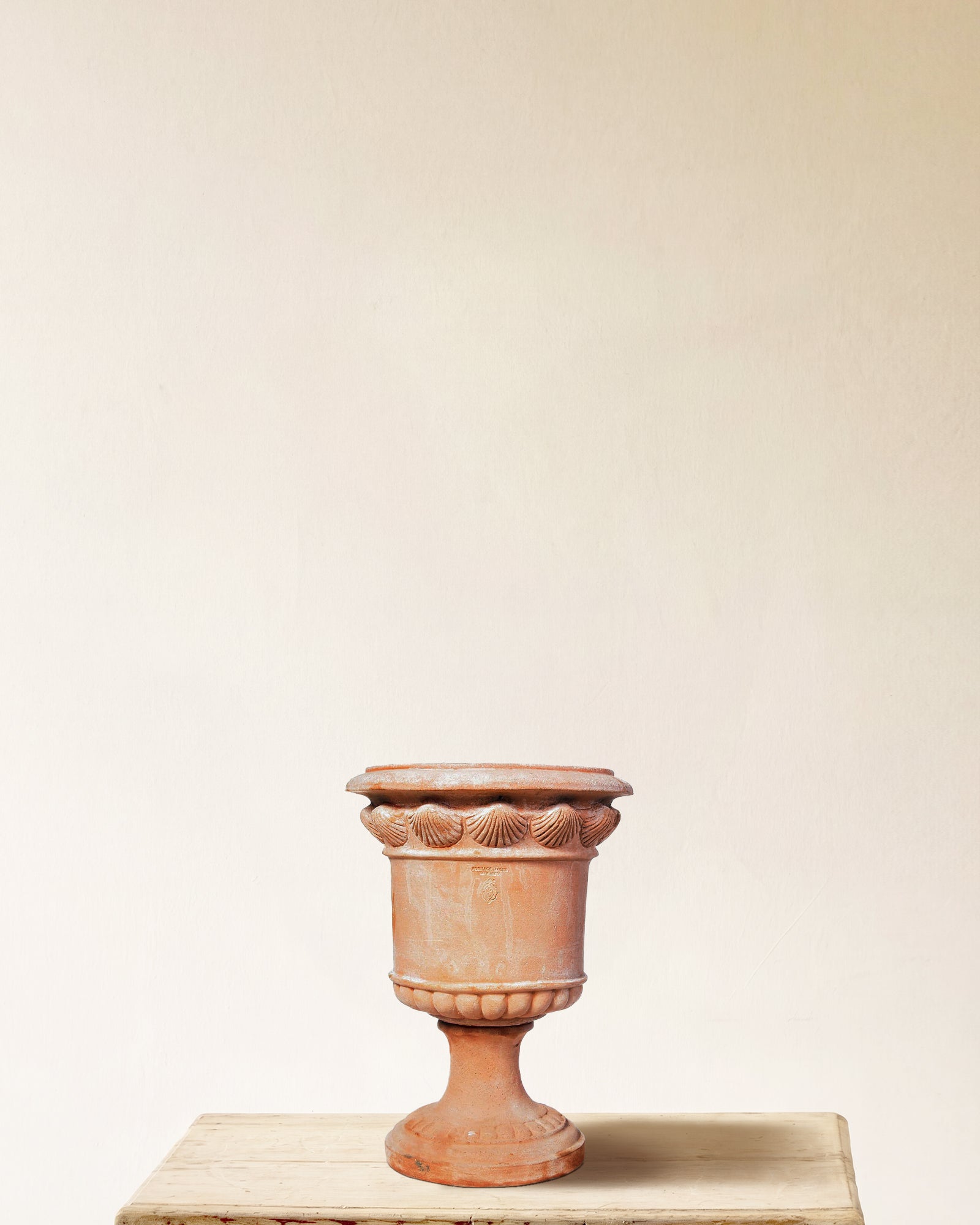 Italian terracotta planter with compact urn form and shell relief band below rim, made in Impruneta, 13" x 17"
