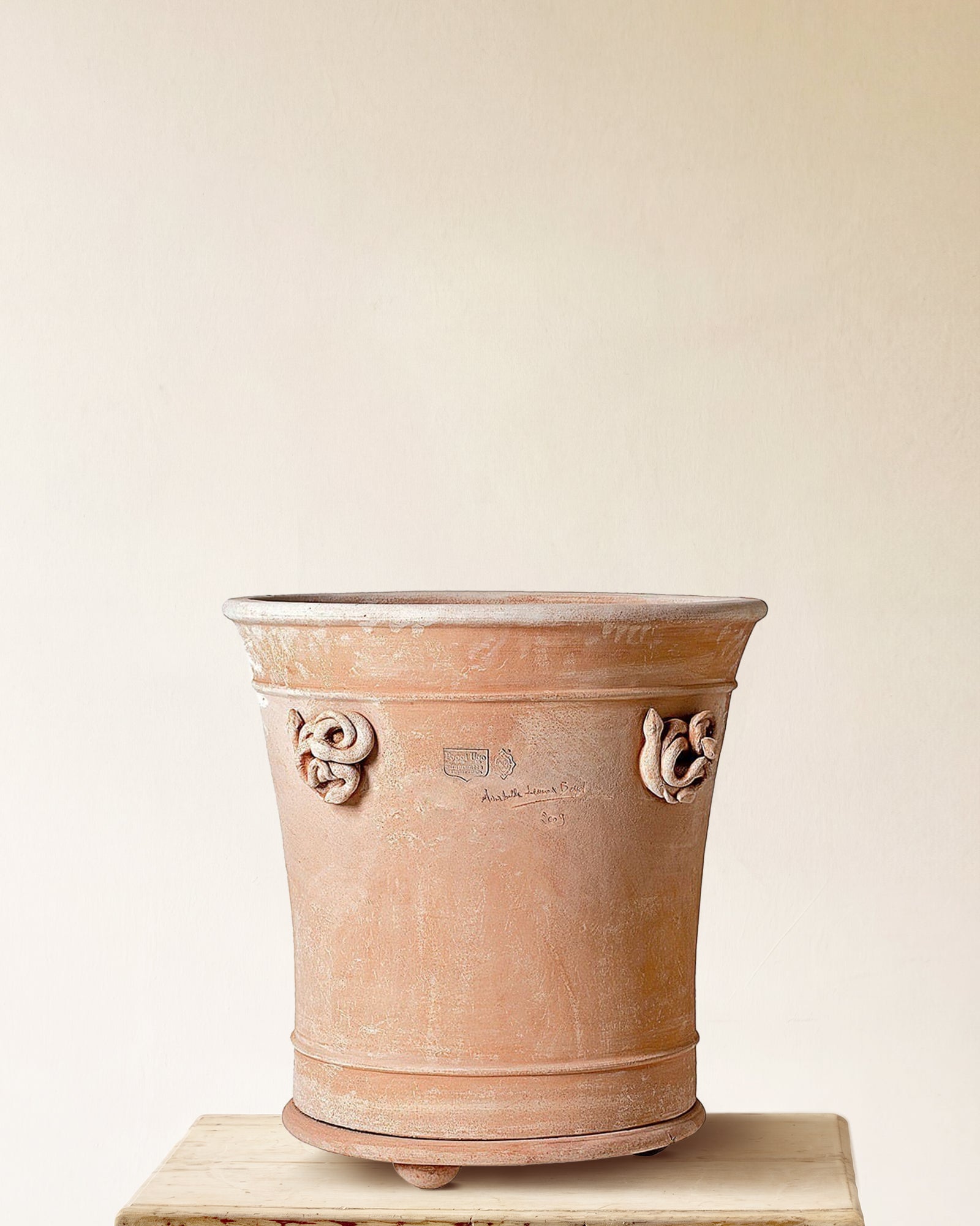 Italian terracotta planter with tall cylindrical form and sculpted serpent forms set at either side, made in Impruneta, 26" x 30"