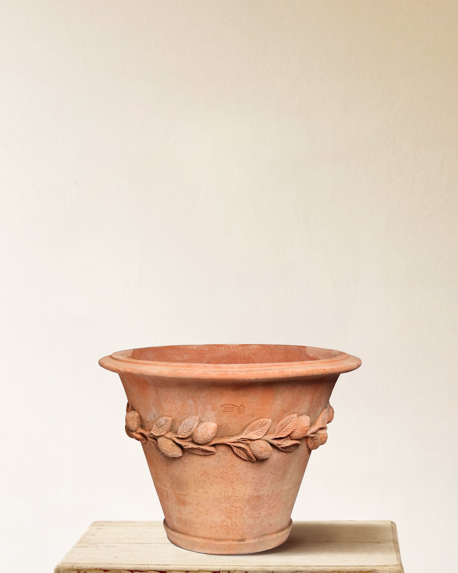 Italian terracotta planter with flared form and sculpted lemon and leaf band, made in Impruneta, 25" x 23"