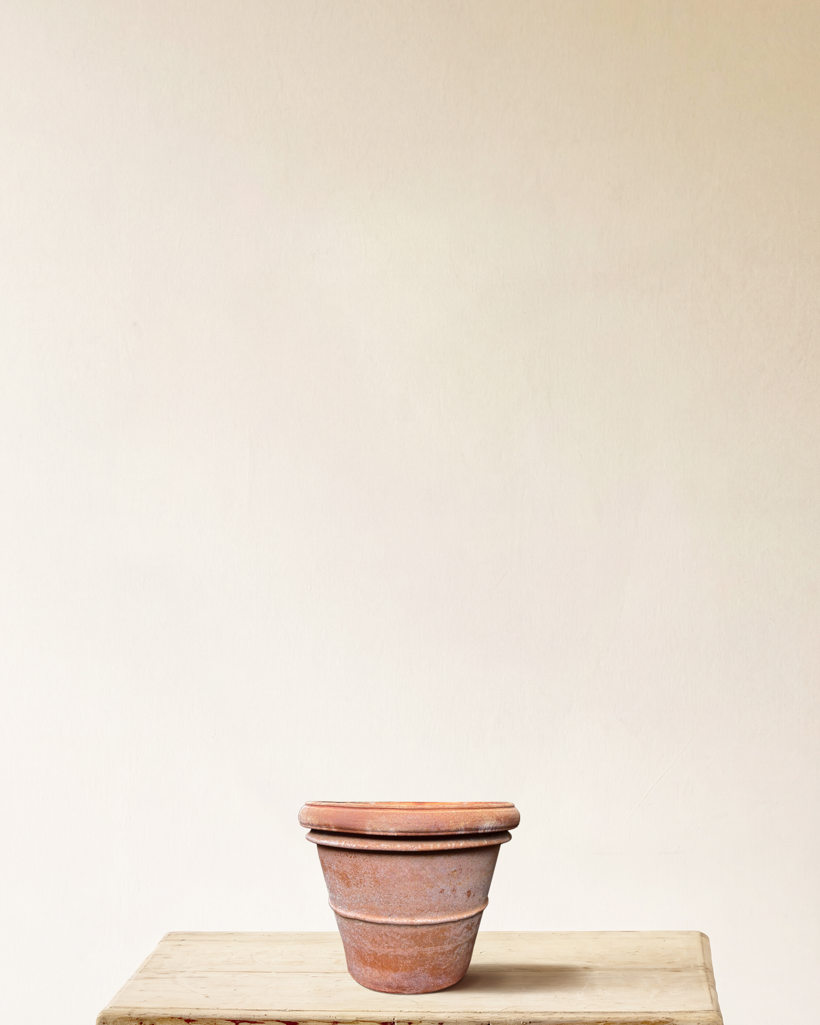 Italian terracotta planter with rounded form and wide rolled rim, smooth surface, made in Impruneta, 12" x 10"